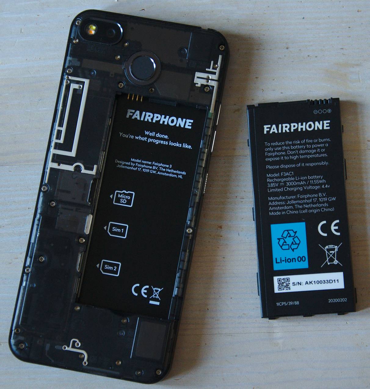 photo of the phone with the battery removed, lying next to it